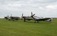 Duxford Airport, Cambridge, England United Kingdom (EGSU) - PART OF THE FLIGHT LINE AT DUXFORD ON A VERY DULL AND RAINY DAY. - by Martin Browne
