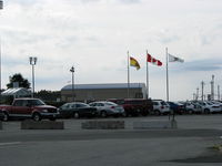 Saint John Airport - Flags flying near the main parking lot at the Saint John Airport - by Peter Pasieka