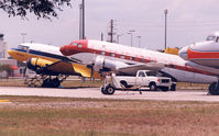 Opa-locka Executive Airport (OPF) - Yellow plane is N50E , cn 11657  DC-3A

Red plane is  N212DD , cn 43389  C-117D

Nose  N381AA , DC-7BF  cn 44921 - by Henk Geerlings