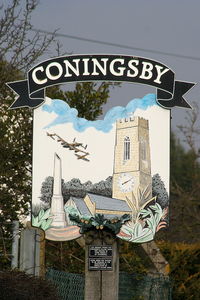 RAF Coningsby Airport, Coningsby, England United Kingdom (EGXC) - Village sign at Coningsby featuring the Battle of Britain Memorial flight - by Chris Hall