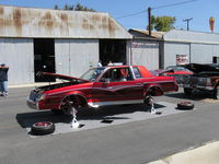 Santa Paula Airport (SZP) - First Sunday Aviation Museum of Santa Paula Open House & Fly-In invites car clubs-another hydraulic-jacked GM custom car on jacks to show off suspension, wheels  & hydraulics. - by Doug Robertson