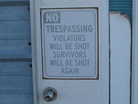 Santa Paula Airport (SZP) - Hangar Warning Sign-I recall when this hangar door posted Support Search and Rescue-GET LOST - by Doug Robertson