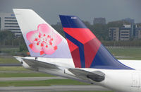 Amsterdam Schiphol Airport, Haarlemmermeer, near Amsterdam Netherlands (EHAM) - Tail from China Airlines B747 , B-18201 and Delta - by Henk Geerlings