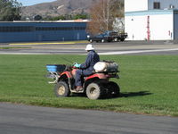 Santa Paula Airport (SZP) - Slow commercial spraying with extended hand nozzle-Rwy 22L grass. Breathing mask, gloves worn. - by Doug Robertson
