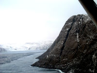Grise Fiord Airport - Now on the outbound heading after the overshoot for runway 32. Check out the mountains!
 - by Tim Kalushka
