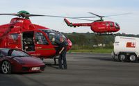 Swansea Airport, Swansea, Wales United Kingdom (EGFH) - Busy day at the Wales Air Ambulance base as the mid-Wales helicopter lands for fuel. - by Roger Winser