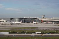 Miami International Airport (MIA) - TAP Air Portugal pulling out of the gate between Air France and Avianca - by Florida Metal