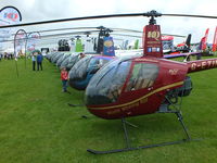 Sywell Aerodrome Airport, Northampton, England United Kingdom (EGBK) - Line up of Robinson's at AeroExpo 2014 - by Chris Hall