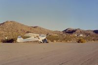 Searchlight Airport (1L3) - N39932 spending the night at Searchlight,Nevada airport).Was not much there in 1990. Lots of opportunity for expansion!! There was some road work for homes and hangars,but nothing more. Northerly view. - by S B J