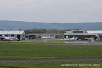 Gloucestershire Airport, Staverton, England United Kingdom (EGBJ) - view across the main apron and hangars at Staverton - by Chris Hall