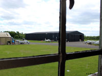 EGYK Airport - A view from the first floor of the Watchtower at RAF Elvington towards some of the displayed exhibits and hangars - by Clive Pattle