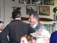 Santa Paula Airport (SZP) - Host Pat Quinn in his Bucker Museum Hangar greeting friends before the luncheon celebrating his 50 year flying FAA Wright Brothers Master Pilot Award. Pat has owned an incredible 55 airplanes in that time!!! - by Doug Robertson