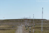 Rankin Inlet Airport - View to southeast of west end of runway with aircraft taxiing in to turn around, @ 1346h.  - by Remi Farvacque