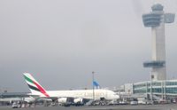 John F Kennedy International Airport (JFK) - Emirates Jumbo A380 boarding near New York JFK International Airport's Control Tower - by Jonas Laurince