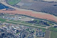 Sutter County Airport (O52) - Overhead Sutter County Airport enroute to Oroville Municipal Airport. Note the fill river abeam the airport. This was taken when Lake Oroville was over capacity and had the dam situation. In fact, mandatory evacuations were made the same day I took this p - by Chris Leipelt