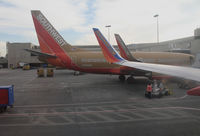 Los Angeles International Airport (LAX) - SOUTHWEST 737-7H4 N768SW and wing of sister ship at Terminal 1 - N768SW in old colors, sister ship in new colors and both with winglets - by Steve Nation