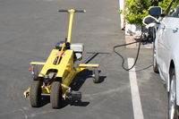Santa Paula Airport (SZP) - This powered dolly moves a Robinson R44 helicopter in and out of its SZP hangar. Dual handle is for steering. - by Doug Robertson